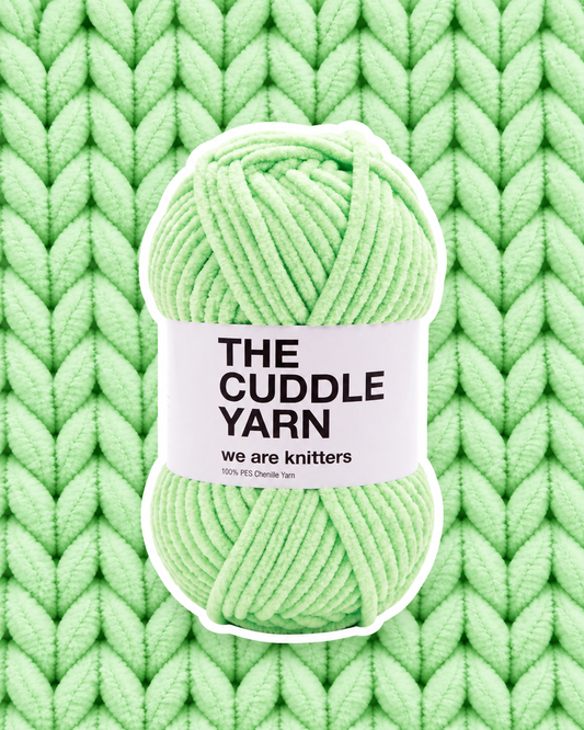 The Cuddle Yarn Green skein on matching knit background